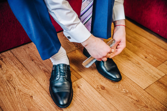 groom knots laces on his shoes