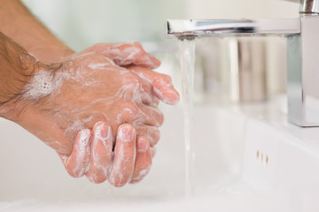 Fototapeta premium Washing hands with soap under running water