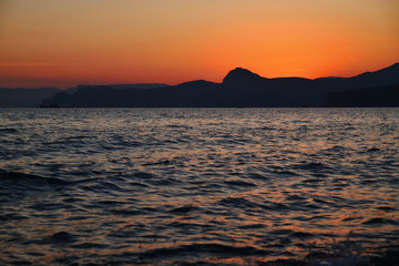 Scenic sunset on the mountain coast at sea