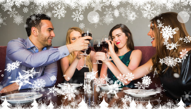 Composite image of a Happy friends drinking red wine in a bar against snow