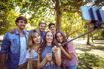 Happy friends in the park taking selfie