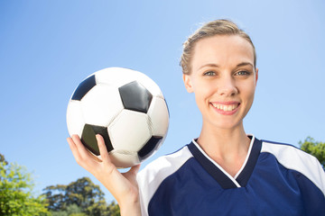 Pretty football player smiling at camera