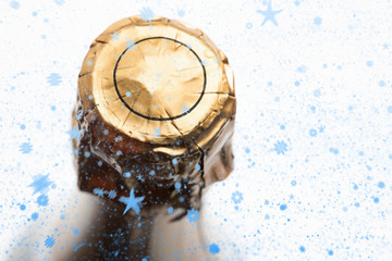 Snow falling against foil on champagne bottle