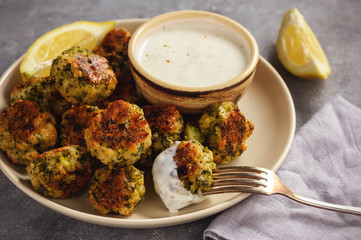 Baked broccoli cheese balls with garlic dip, vegetarian food.