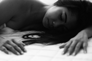 Young woman in bedroom sensuality black and white concept sleeping