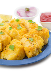 Indian Street Food Khaman Dhokla is a Food Common in The Gujarat State of India Made From Soaked And Freshly Ground Channa Dal or Channa Flour isolated on White Background