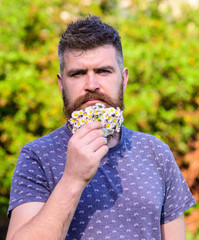Barber and hairstyle concept. Bearded man with daisy flowers in beard. Man with beard and mustache...