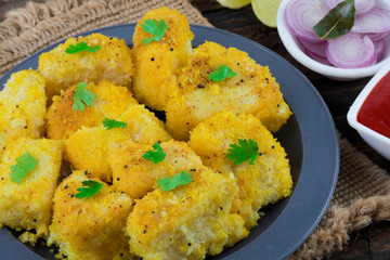 Indian Street Food Khaman Dhokla is a Food Common in The Gujarat State of India Made From Soaked And Freshly Ground Channa Dal or Channa Flour on Wooden Background