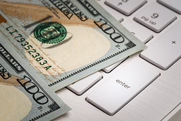 Closeup banknote USD 100 dollar with keyboard and enter