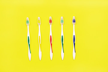 Toothbrushes on yellow background