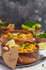 Vegan Sweet Potato Chickpea curry in wooden bowl on light background. Healthy vegetarian food concept.
