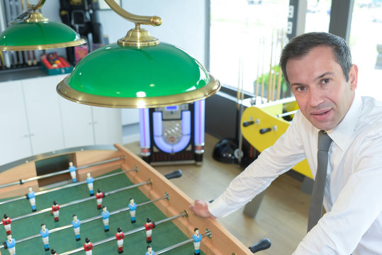 businessman posing near fusball