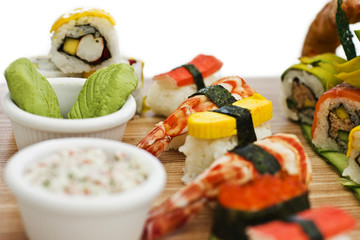 Japanese food - Sushi, sashimi, rolls on a wooden board. Isolated