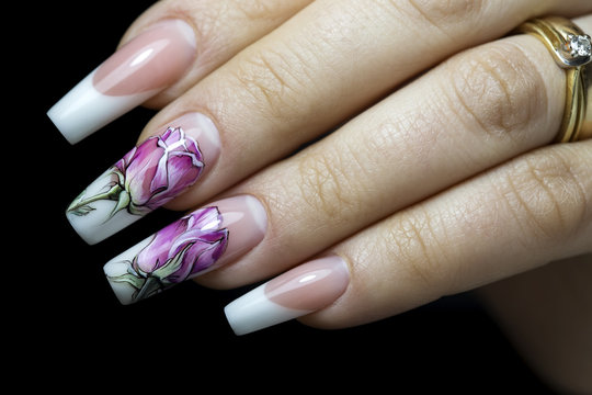 Beautiful multicolored flowers on a transparent lacquer on the nails