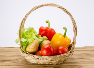 Fresh vegetable in basket on wood desk, groceries product and voucher gift concept. Diet food with clean fresh vegetable gift from nature to be healthy life.