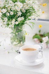 Obraz na płótnie Canvas cup of morning coffee with flowers