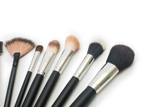 makeup brushes on isolated white background