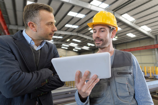 warehouse team discussing with digital tablet in warehouse