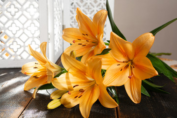 Sensual bouquet of beautiful orange lilies flowers close up