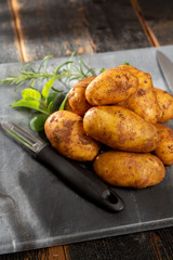 New harvest potatoes not washed with soil on table