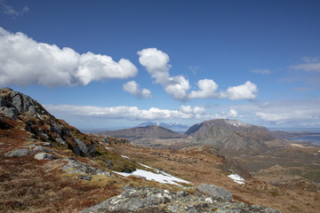 Fototapeta na wymiar Blue skies and clouds in great spring weather on Bronnoy mountain in Northern Norway