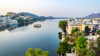 Udaipur city at lake Pichola in the morning, Rajasthan, India. View of City palace reflected on the...