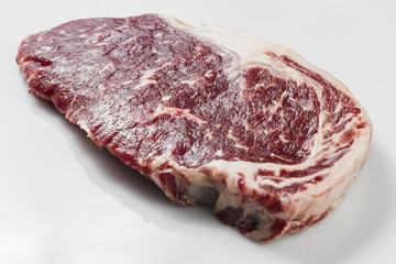 Ripened seasoned beef rump or striploin steak on white background isolated