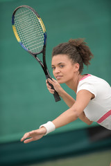 tennis female player hitting ball with forehand