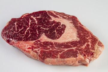 Ripened seasoned beef rib eye or entrecote steak on white background isolated