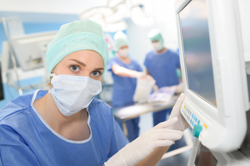 surgeon looking at medical monitor during surgery