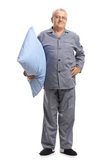 Mature man in pajamas holding a pillow
