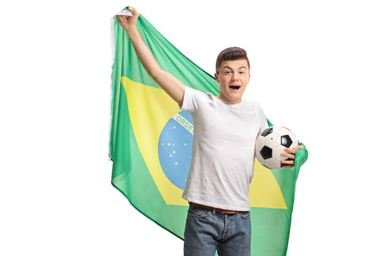 Joyful teenage soccer fan holding a football and a Brazilian flag