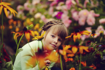 little girl in the garden with flowers