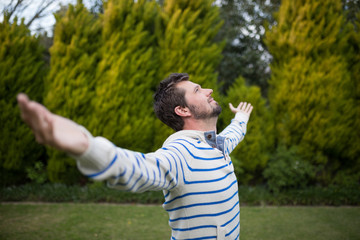 Man standing with arms wide open