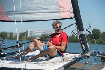confident captain of sail boat looking out to sea