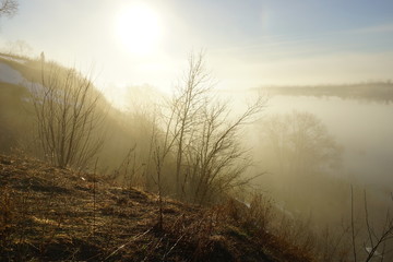 morning spring fog over the river rises the sun is melting snow beautiful scenery