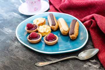 Mixed dessert Raspberry tartlet, Eclair Puffs, almond lemon