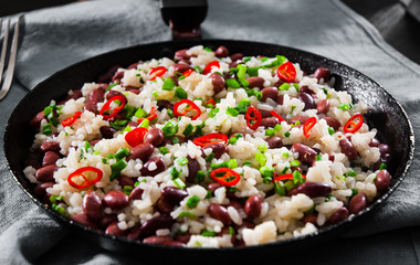 rice with red beans and vegetables in a frying pan