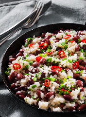 rice with red beans and vegetables in a frying pan