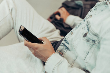 man sitting at the airport talking on smartphone