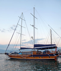 Fototapeta na wymiar Wooden luxury yacht in the sea at sunset