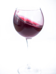 A glass with red wine on a white background. Isolate