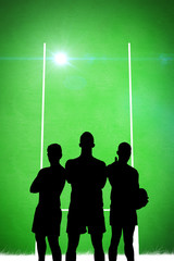 Fototapeta na wymiar Silhouette of rugby player against green background