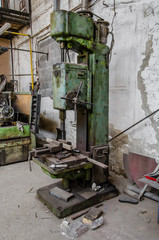 Large vintage drilling machine in a metalwork shop
