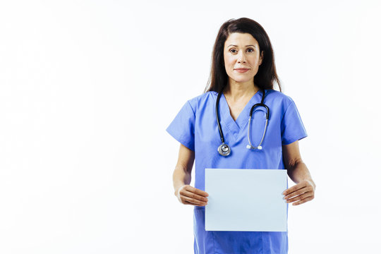 Portrait Of A Female Nurse Or Doctor In Blue Uniform Holding A Blank Sign Isolated On White Studio Background