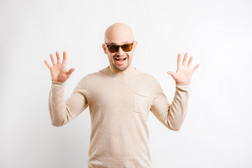 Adult bald happy businessman in sunglasses showing thumbs up. Cheerful smiling man face expression. Agree hands gestures. Successful guy portrait.  Everything`s fine.  No problem.  Excited male person