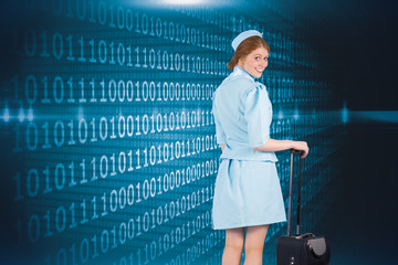 Pretty air hostess leaning on suitcase against shiny blue binary code on black background