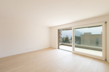 Empty white room with large window with a view.