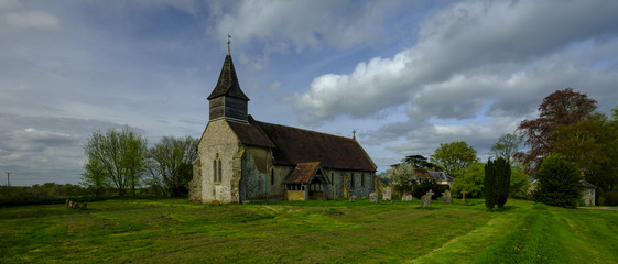 Fototapeta premium Spring afternoon light on the church of St Peter Ad Vincula - now no longer in regular use - in the village of Colemore within the South Downs National Park, Hampshire, UK