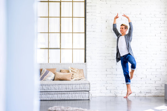 A handsome young male Ballet dancer practicing in a Loft style A
